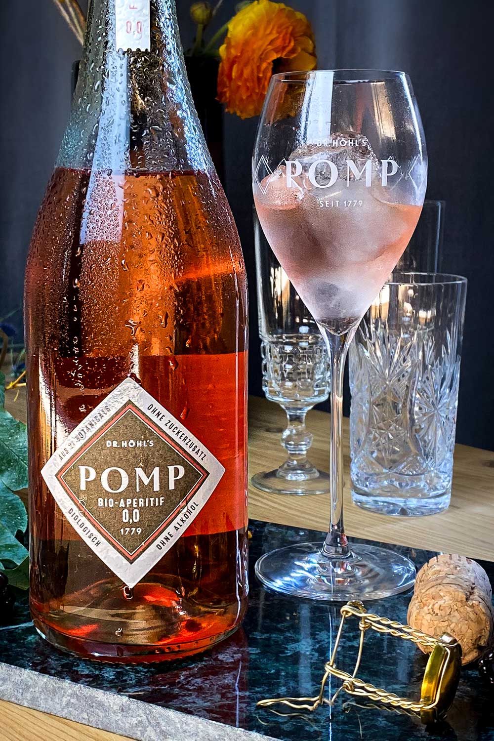 pomp sektglas mit alkoholfreiem bio aperitif rosé und eiswürfeln gefüllt