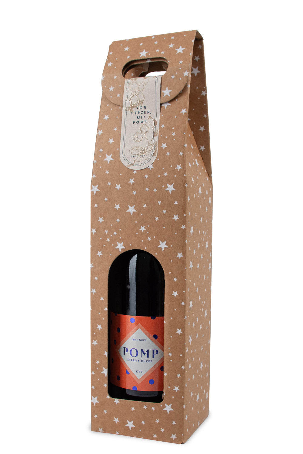 eine flasche sekt mit orangenem etikett und blauen punkten in einer naturkarton geschenkbox mit weißen sternchen und tragegriff seitlich