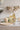 tisch mit boho babyshower deko und einer flasche alkoholfreier sekt
